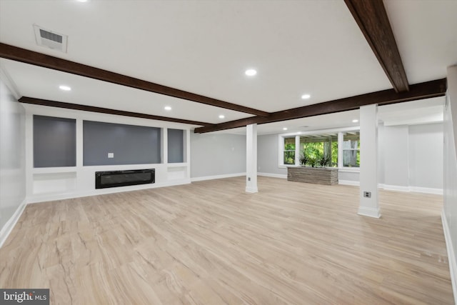 unfurnished living room with beamed ceiling and light hardwood / wood-style flooring