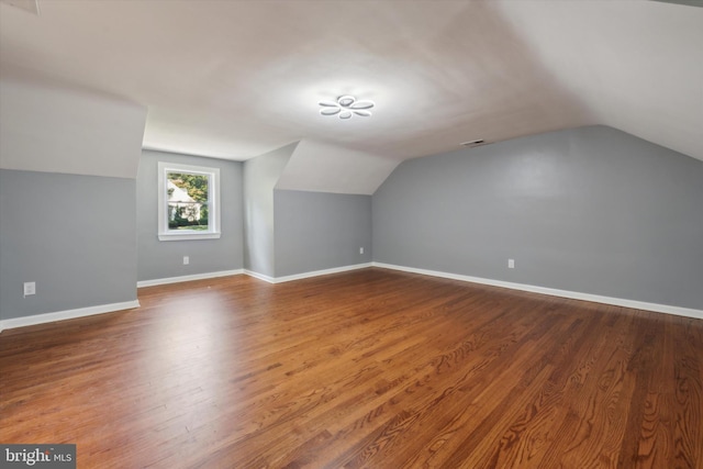 bonus room with vaulted ceiling and wood-type flooring