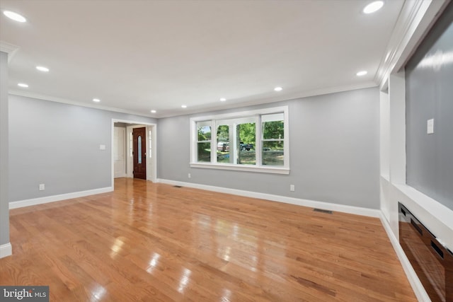 interior space featuring crown molding and light wood-type flooring