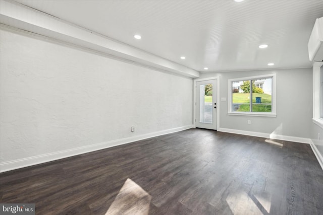 unfurnished room with dark wood-type flooring and vaulted ceiling