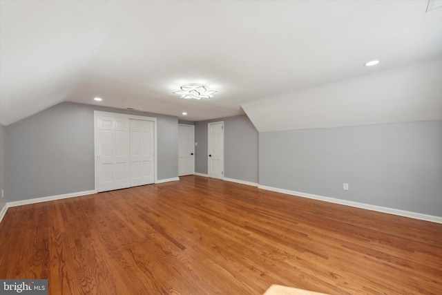 additional living space with lofted ceiling and wood-type flooring