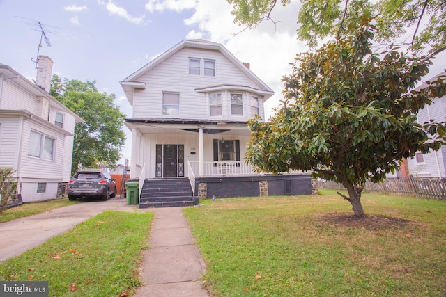 view of front of property featuring a porch and a front lawn