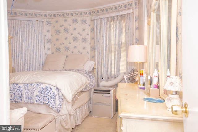 carpeted bedroom featuring crown molding