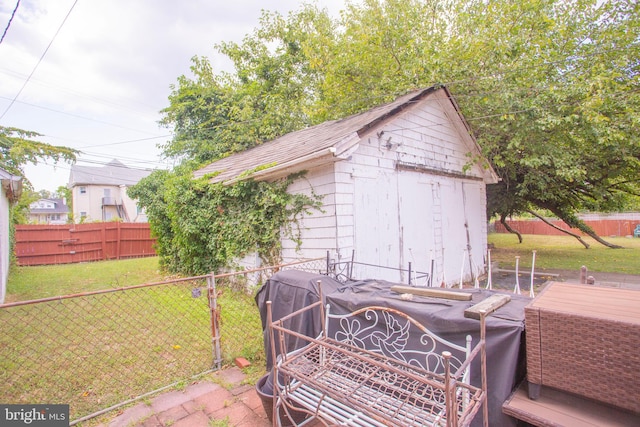 view of outbuilding featuring a yard