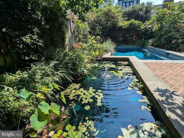 view of swimming pool with a fenced in pool and fence