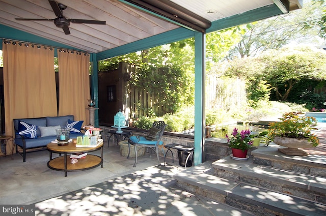 view of patio with an outdoor living space and ceiling fan