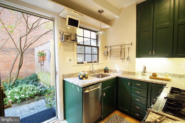 kitchen featuring sink, green cabinetry, decorative light fixtures, stainless steel appliances, and light stone countertops