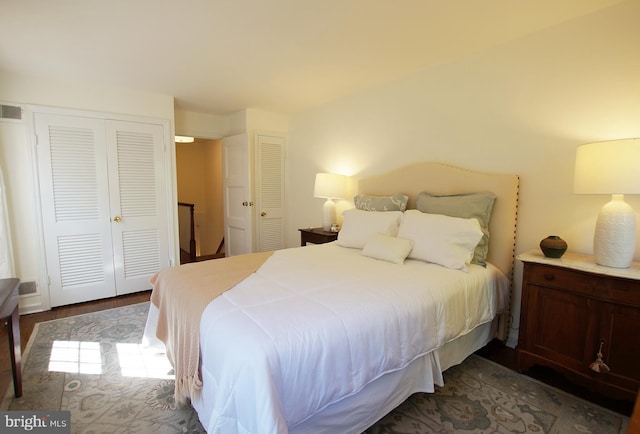 bedroom featuring two closets and dark wood-type flooring