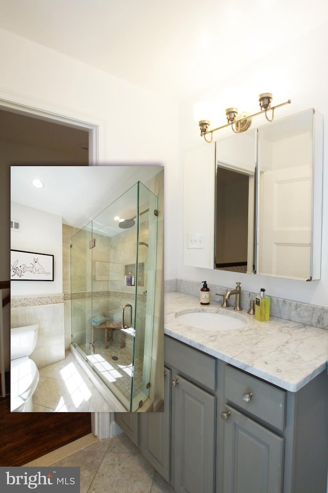 bathroom featuring vanity, toilet, an enclosed shower, and tile patterned floors