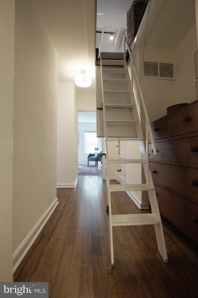 stairway featuring hardwood / wood-style floors