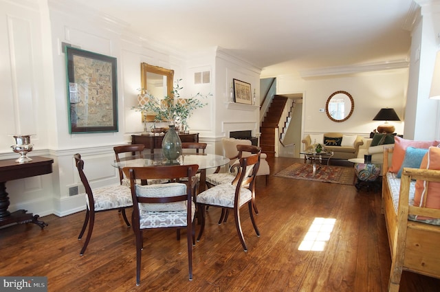 dining room featuring crown molding and dark wood-type flooring