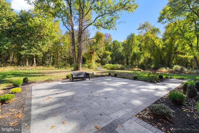 view of patio / terrace with a wooded view