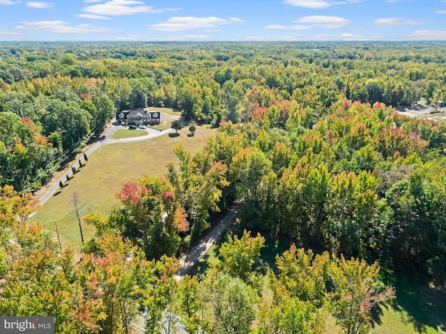 birds eye view of property featuring a view of trees