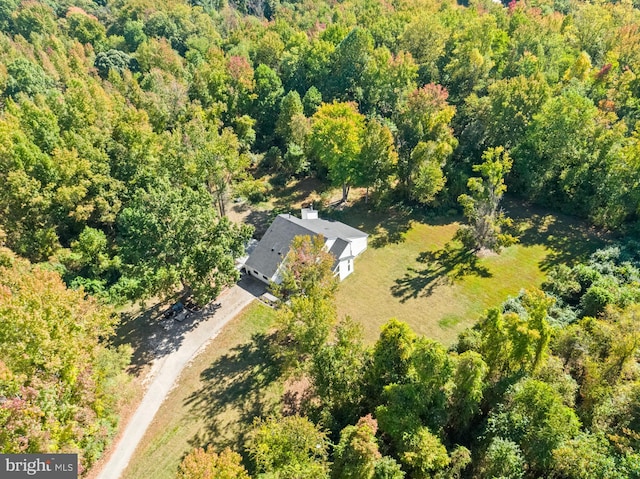 drone / aerial view featuring a view of trees