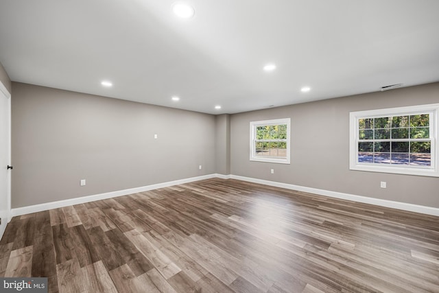 unfurnished room featuring visible vents, recessed lighting, baseboards, and wood finished floors