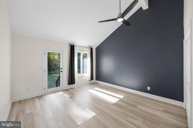 spare room with light wood finished floors, baseboards, high vaulted ceiling, and a ceiling fan