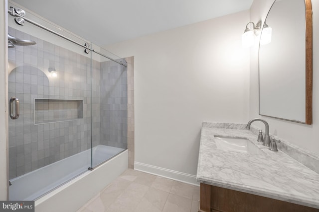 full bath featuring tile patterned floors, baseboards, vanity, and enclosed tub / shower combo