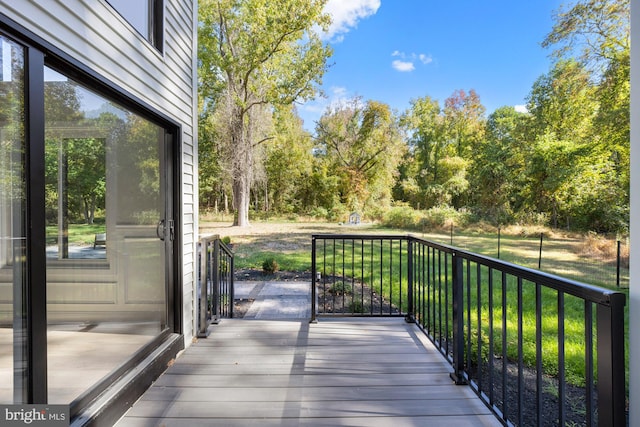 wooden deck featuring a yard