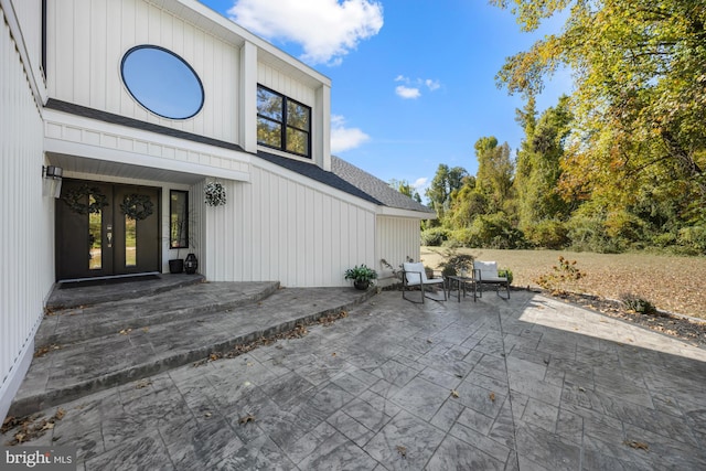 view of exterior entry featuring a patio and french doors