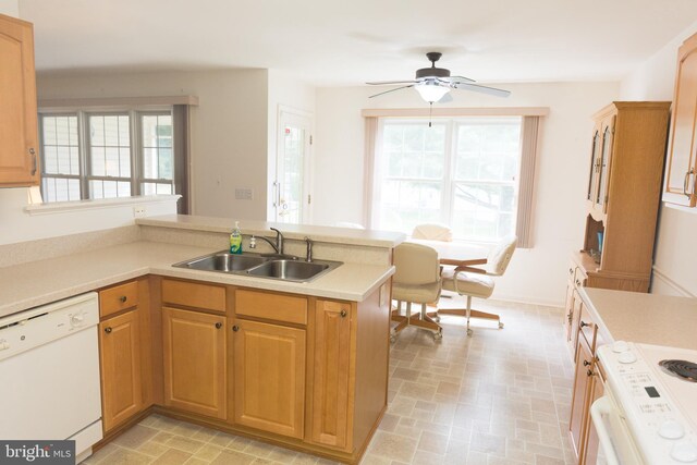 kitchen with white appliances, washing machine and dryer, and ceiling fan