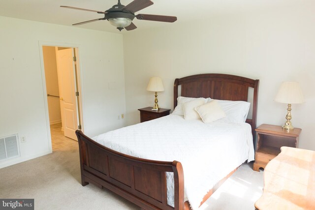 bedroom featuring light carpet and ceiling fan