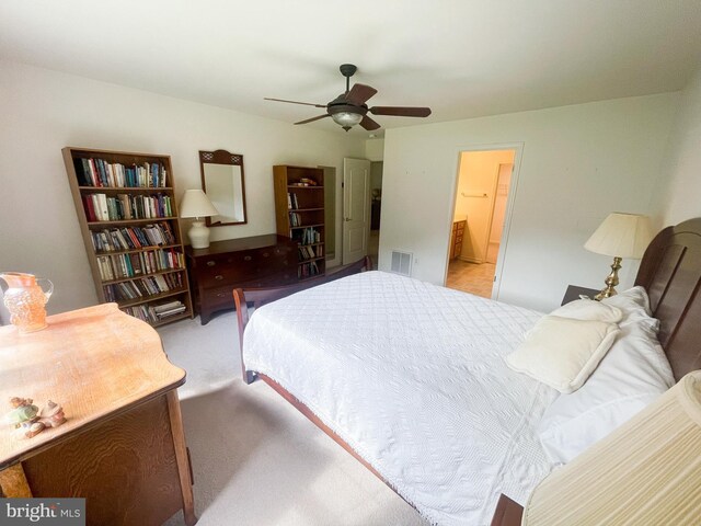 bedroom featuring light carpet and ceiling fan