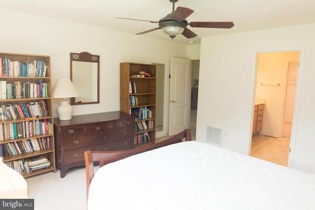 carpeted bedroom featuring ceiling fan and ensuite bathroom