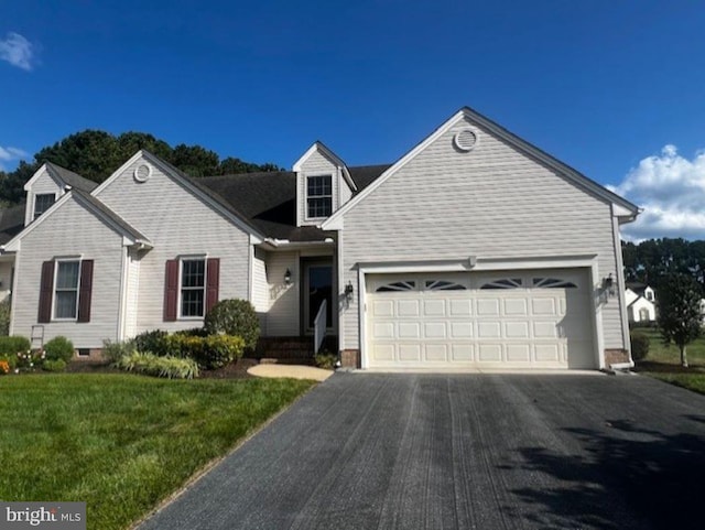 view of front of house with a front yard and a garage