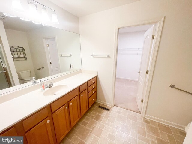 bathroom with walk in shower and vanity