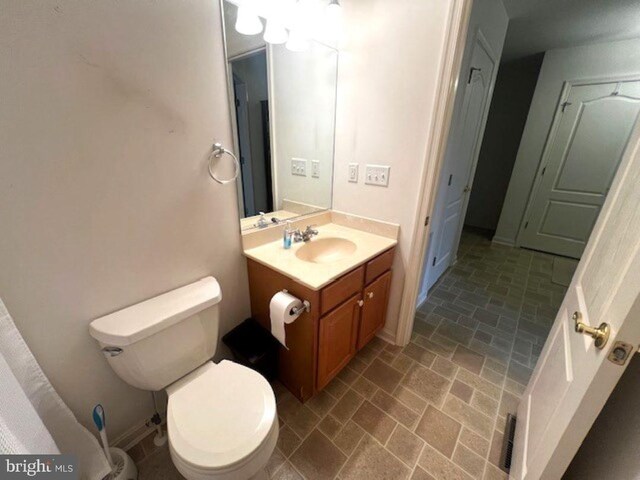 full bathroom with  shower combination, vanity, and toilet