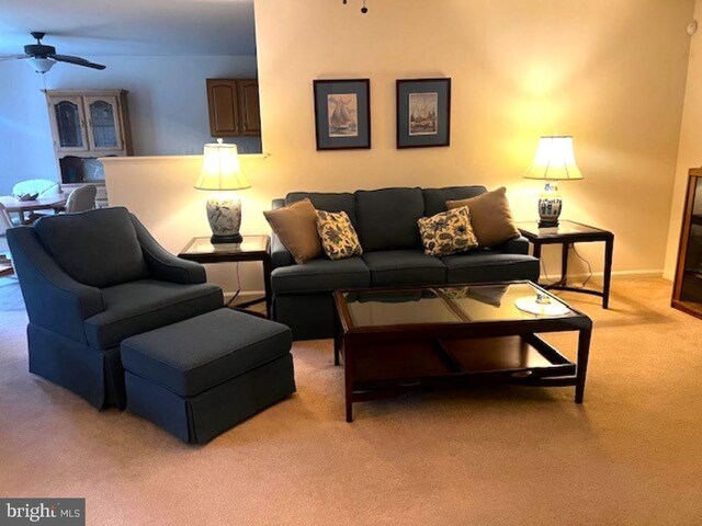 carpeted living room featuring ceiling fan