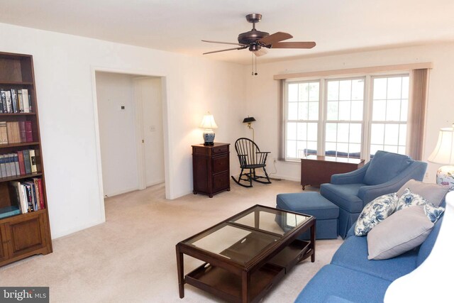 living room with light carpet and ceiling fan