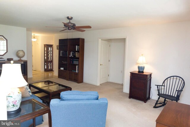 living room with ceiling fan and light colored carpet