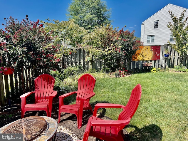 view of yard with an outdoor fire pit