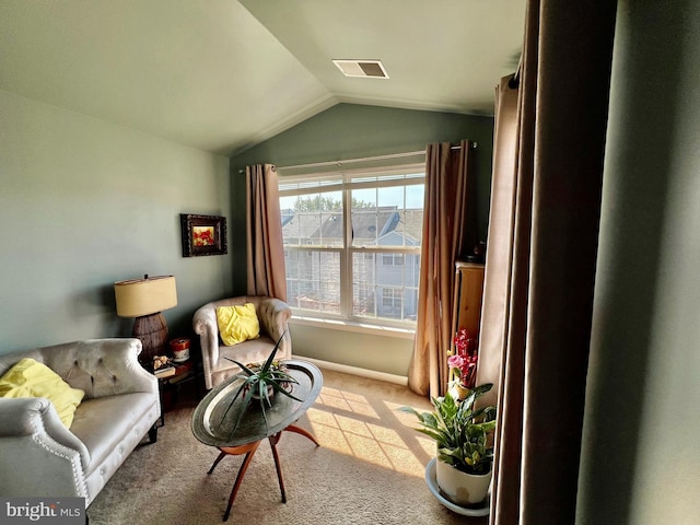 living area with light colored carpet and vaulted ceiling