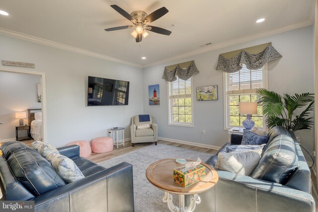 living room with ceiling fan, light hardwood / wood-style floors, and crown molding