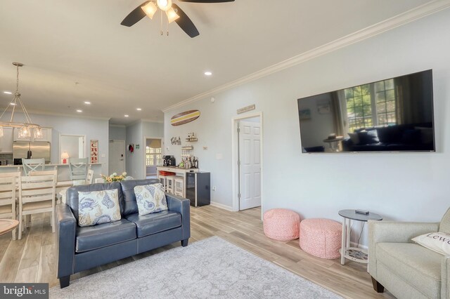 bedroom with light wood-type flooring, ornamental molding, and ceiling fan