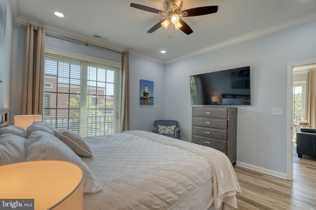 bedroom featuring ceiling fan, light hardwood / wood-style floors, and crown molding