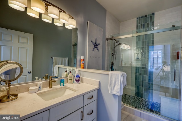 bathroom with walk in shower and vanity