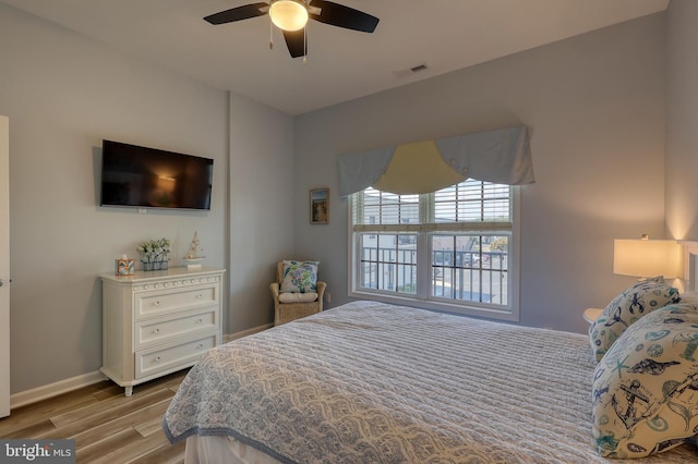 bedroom featuring ceiling fan and light hardwood / wood-style floors