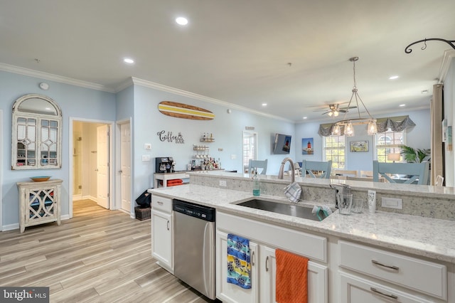 kitchen with light stone countertops, pendant lighting, light hardwood / wood-style floors, stainless steel dishwasher, and white cabinets