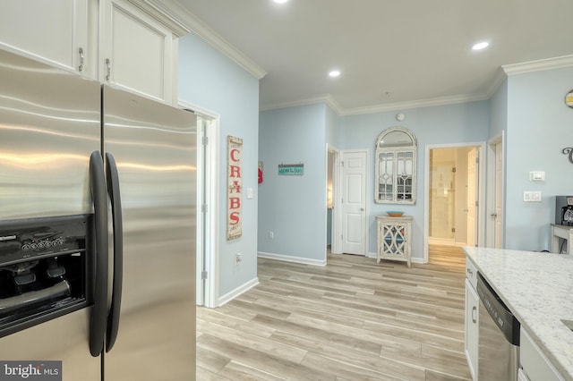 kitchen with light hardwood / wood-style flooring, stainless steel appliances, ornamental molding, light stone counters, and white cabinets