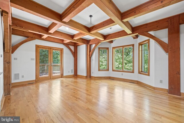 additional living space featuring light hardwood / wood-style flooring, french doors, and beam ceiling