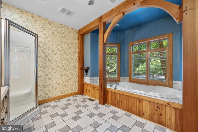 bathroom featuring ceiling fan, shower with separate bathtub, and vanity