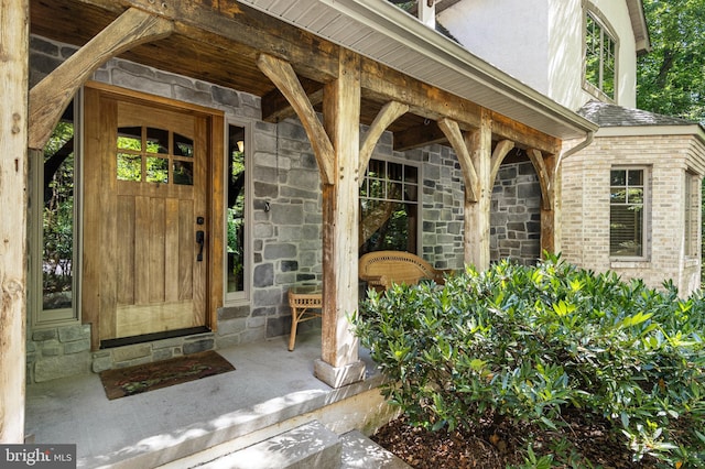 view of exterior entry with a porch