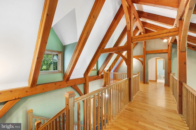 hall featuring high vaulted ceiling and light hardwood / wood-style floors