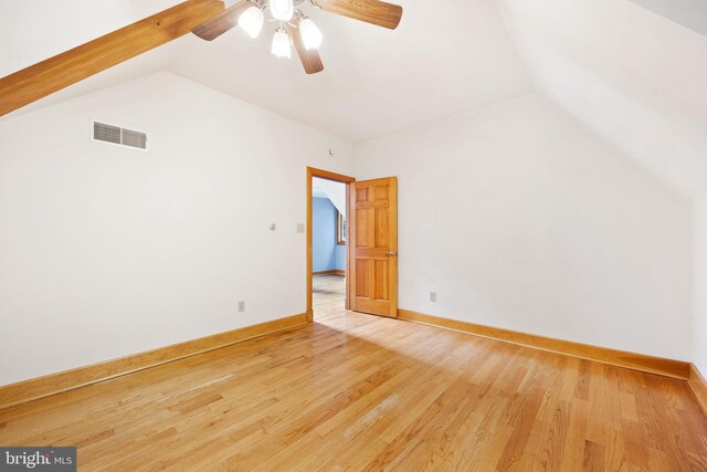 empty room featuring lofted ceiling, ceiling fan, and wood-type flooring