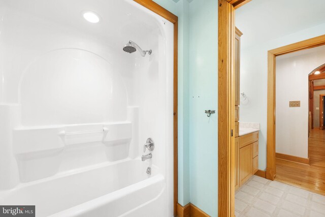 bathroom featuring vanity, hardwood / wood-style flooring, and bathtub / shower combination