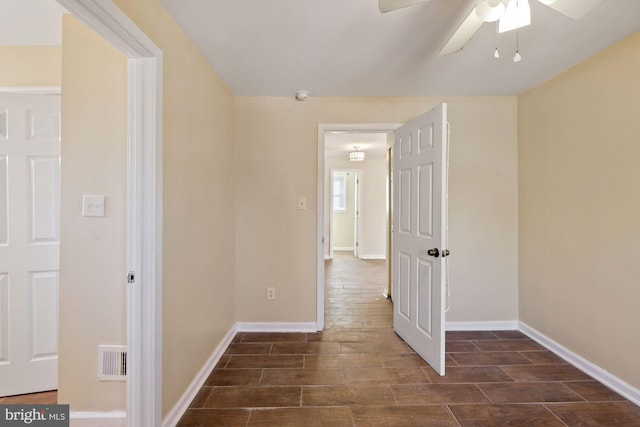 interior space with ceiling fan and dark wood-type flooring