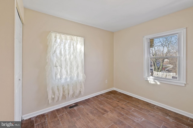 empty room with hardwood / wood-style flooring